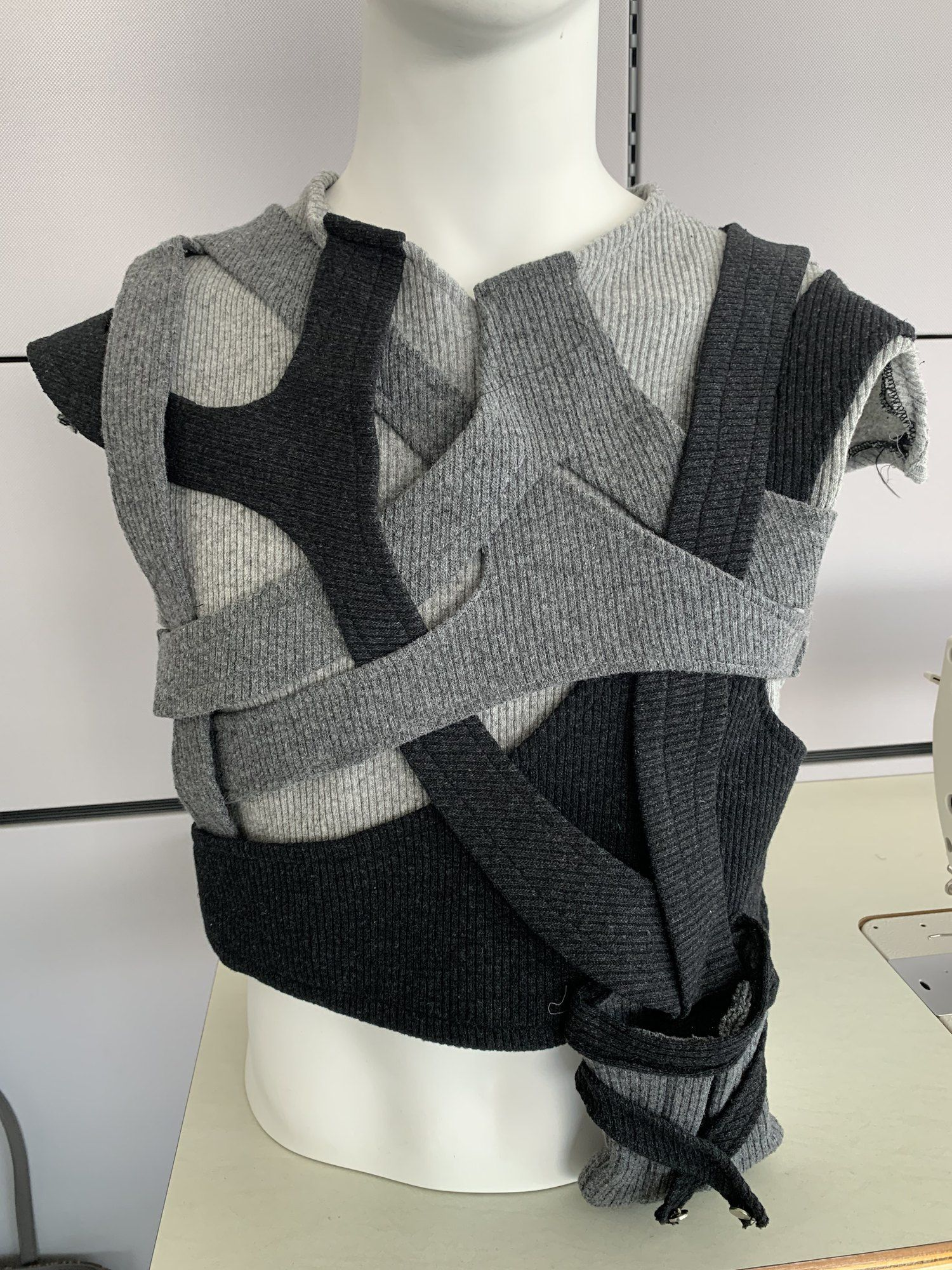 Grey knit strap top on a mannequin, detail